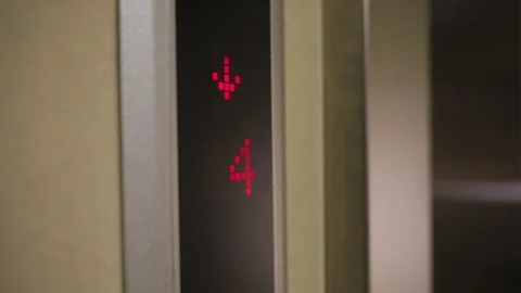 Elevator Display Showing Downward Arrow and Floor 4 in Modern Corporate Building Stock Footage 306497460
