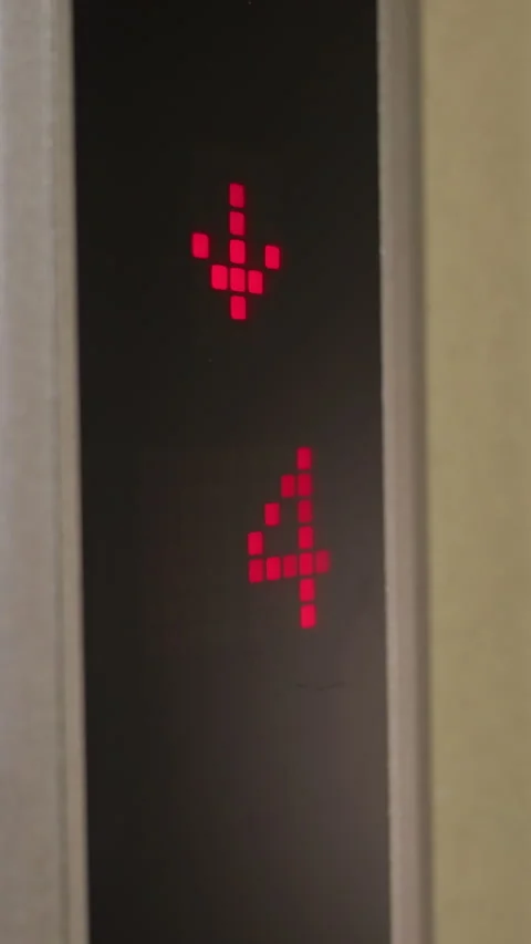 Elevator Display Showing Downward Arrow and Floor 4 in Modern Corporate Building Stock Footage 318807390