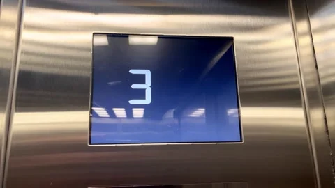 The elevator display shows a seamless transition from one to two and then three Stock Footage 317496425