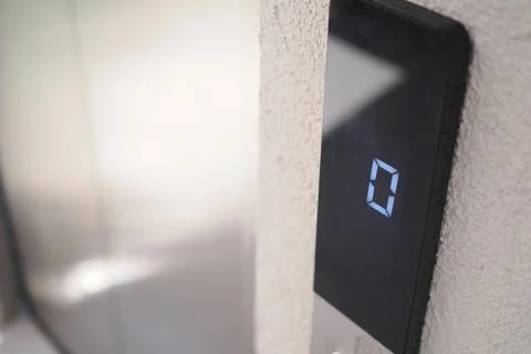 Elevator display shows zero at entrance Stock Photos