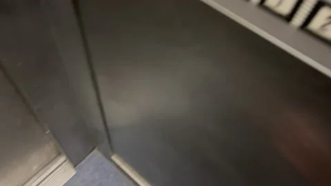 Elevator door closing and child hand pressing second floor button Stock Footage 230227952