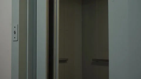 An elevator door opening in a dim hallway Stock-Footage 327680936