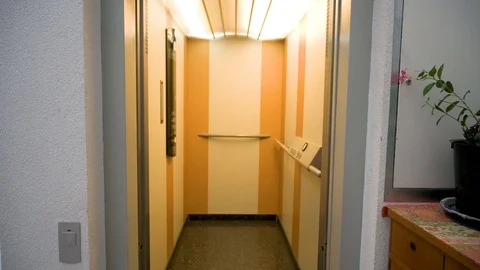 The elevator door opens and shows the interior of an elevator Stock Footage 121531332