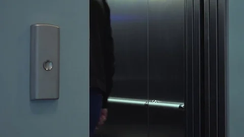 An elevator door slides open and a man walks in - closeup Stock-Footage 82233842