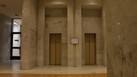 Elevator doors open and close on an empty floor Stock Footage