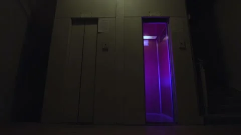 Elevator doors open and close on an empty floor with flashing disco lights Stock Footage 152035454