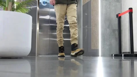 Elevator doors open and a man comes out Stock Footage 255902023
