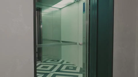 The elevator doors open. Opening the door is an elevator. Metal doors smoothly Stock Footage 293573216