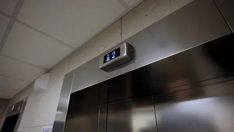 Elevator doors show glowing digital floor indicator 스톡 동영상 332736958
