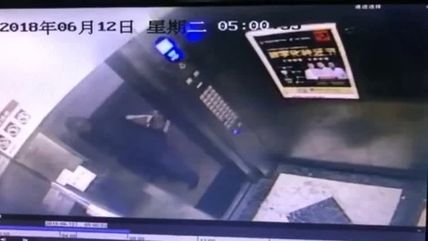 Elevator drags bicycle up after getting stuck in doors Stock Footage 106314948