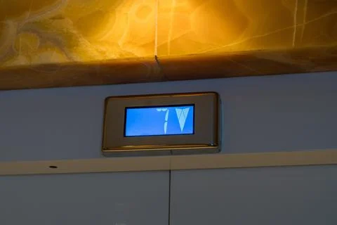 Elevator floor indicator display showing number seven and arrow Stock Photos