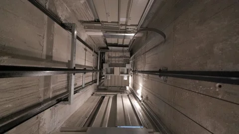 Elevator lift cabin moves up inside illuminated elevator shaft with Stock Footage 138167004