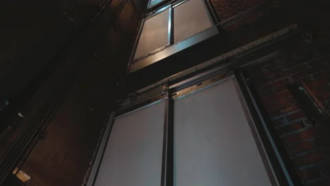 Elevator lift cabines up inside illuminated elevator shaft with hydraulics w Stock Footage 148614640