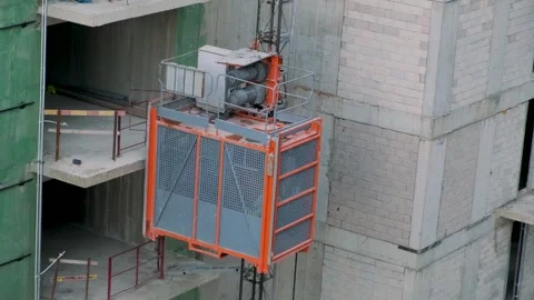 Elevator lifts for workers and construction materials at the construction site Stock Footage 252768354
