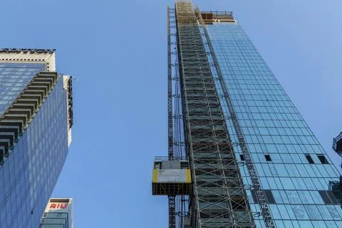 Elevator lifts for workers and materials at the construction site of a new Stock Photos