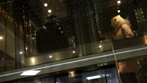The elevator in the mall goes up. People in the elevator. Stock Footage 135689265