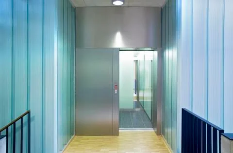 Elevator in a modern building, mixed construction material glass, wood, metal Fotos de archivo