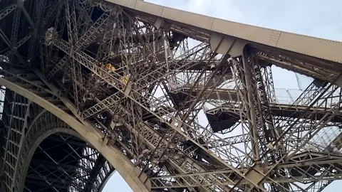Elevator moving down with passengers on Tour Eiffel in Paris and people going Stock Footage 249880634
