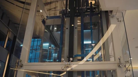 An elevator is moving in a transparent shaft. Shooting an elevator in motion. Stock Footage 158481077
