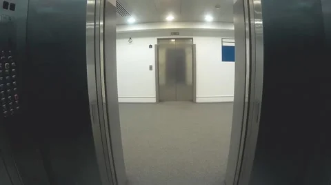 An elevator opens and closes its doors of steel Stock Footage