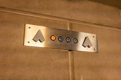 Elevator panel communicating direction and floor of active elevator car Stock Photos