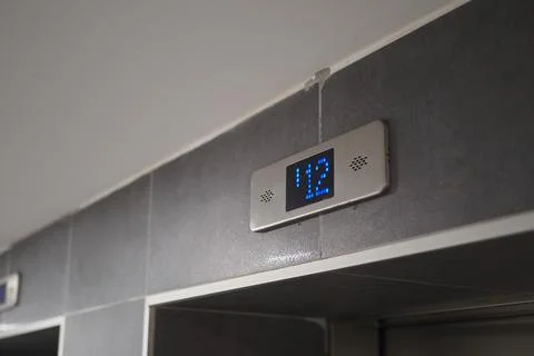 Elevator panel displaying the number twelve in a building lobby area Stock Photos