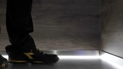 Elevator repair man dropping tool bag inside the lift wearing sneakers, Video stock 169281938