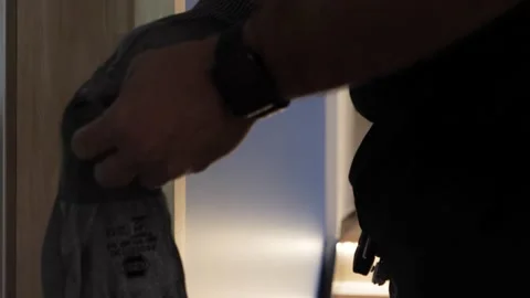 Elevator repair technician putting on work gloves before touching the Video stock 169393846