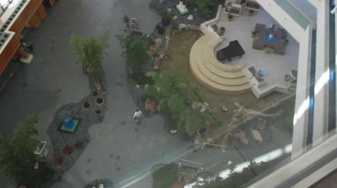 Elevator Ride Down to Ground Level- Busy Hotel Lobby Revealed Stock Footage 58337919