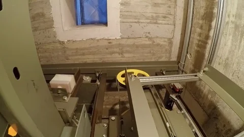 In a elevator shaft, the cabin moves down to the shaft end and stops there.  Видео 88431658