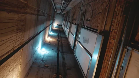 Elevator shaft inside. Elevator cabin moving down slowly in a shaft with bar Stock Footage 148615417