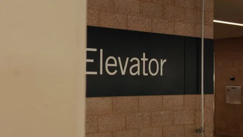 Elevator Sign Hidden Behind Foreground Wall Stock Footage 346201186