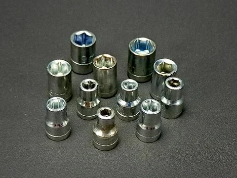 Eleven socket tools are precisely aligned, showcasing a selection of variou.. Stock Photos