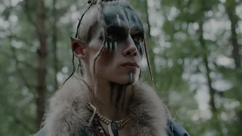 Elf folk representative in costume with fur stands in wood Stock Footage 162158312