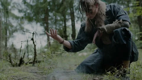 Elf man makes smoke offering to forest ghosts on grass Stock Footage 162158048