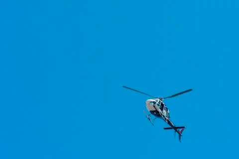 Elicopter overhead in blue sky Stock Photos