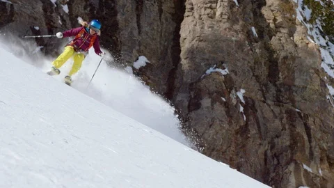 Elite female skier rolling down the fresh powder snow Stock Footage 116747312