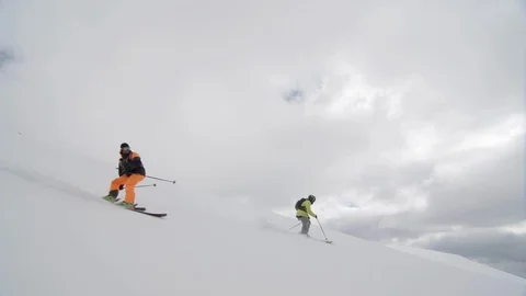 Elite freestyle skiers on speeding down a mountain face Stock Footage 113222373