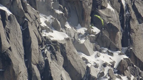 Elite paragliding skier flying down mountain slope and inverting Stock Footage 113248237