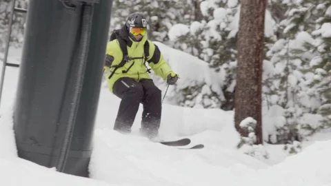 Elite skier bursting through a mound of powder on a woodsy slope Stock Footage 113230034