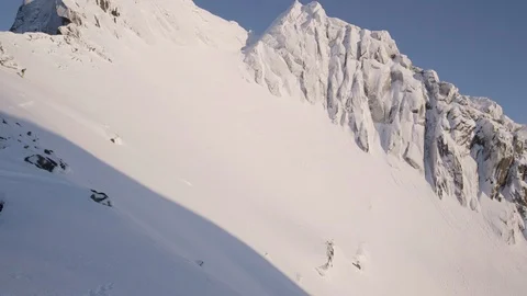 Elite skier cruising down remote mountain summit Stock Footage 113225788