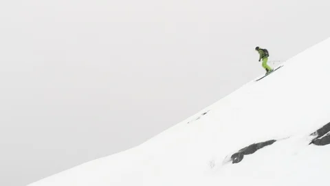 Elite skier cruising down remote mountainside Stock Footage 113226786