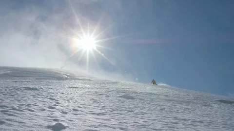 Elite skier cruising down a remote mountain on a sunny day Stock Footage 113256379