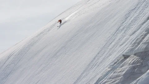 Elite skier cruising down a remote mountain Stock Footage 113256507