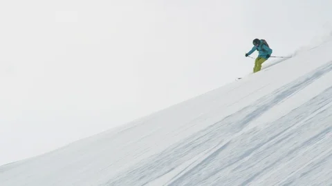 Elite skier cruising down a remote mountain Stock Footage 113260779