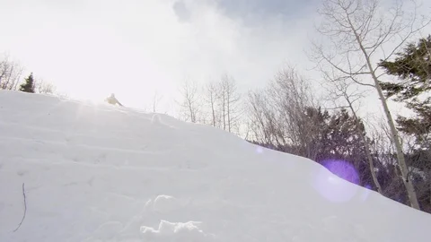 Elite skier cruising down the side of a powder covered mountain Stock Footage 113204370