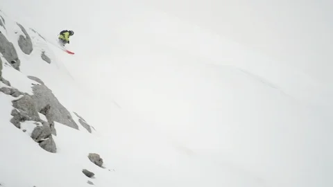 Elite skier cruising down steep mountain face Video stock 113223630