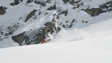 Elite skier cutting through fresh powder on mountain ridge Stock Footage 113217575