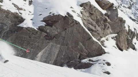 Elite skier cutting through fresh powder on a rocky mountain Stock Footage 113240676