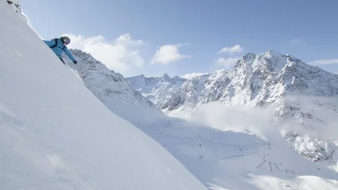 Elite skier cutting through fresh powder on a rocky mountain Stock Footage 113242458